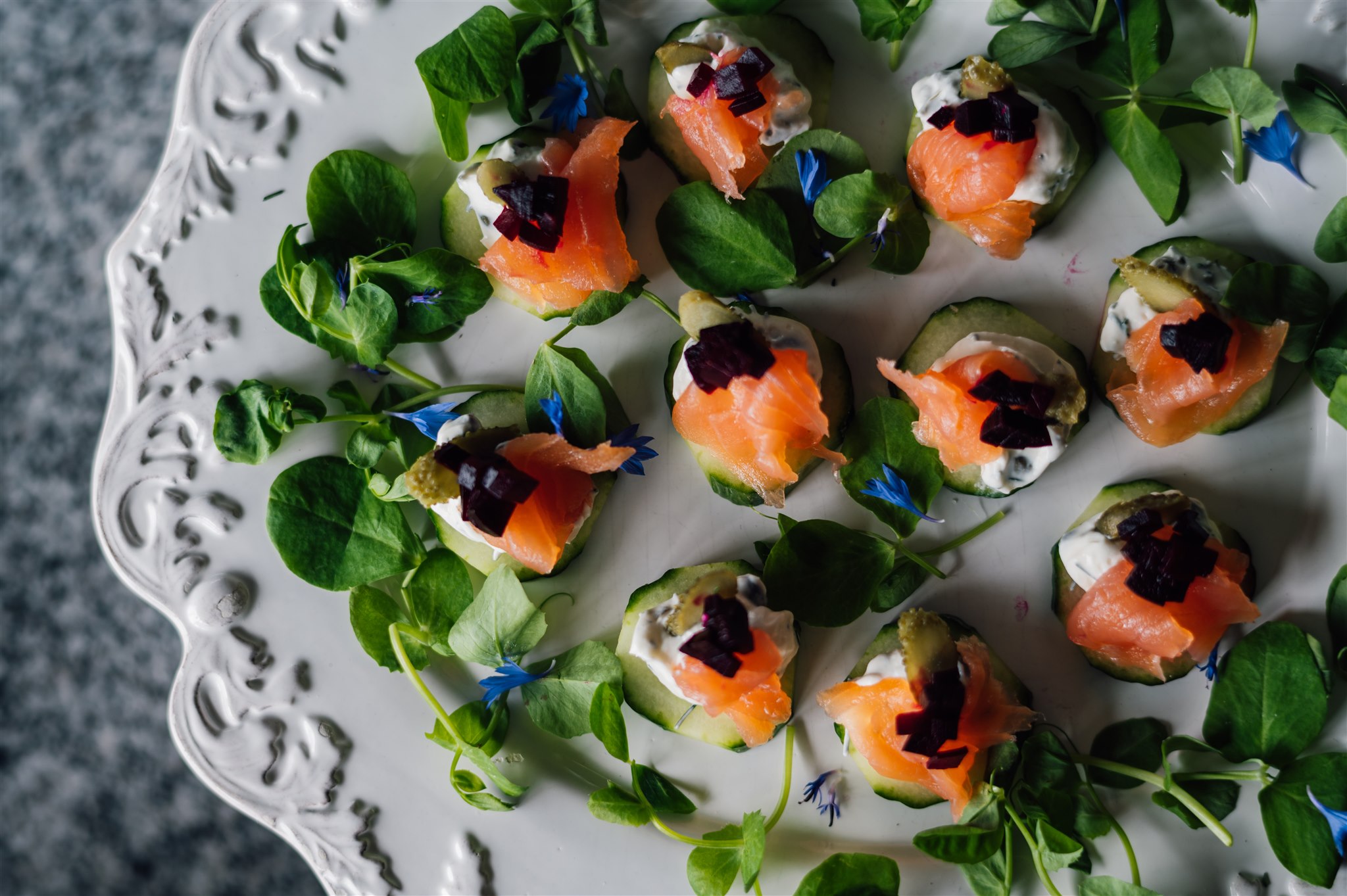 Smoked salmon canapés with watercress and blue borage flowers